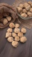Raw soya chunks on dark background. Healthy, nutritious soybean meat, chunks isolated.Vegan food concept. photo