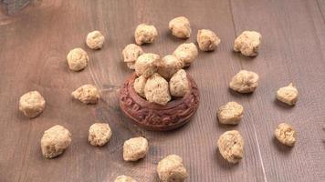 Raw soya chunks on dark background. Healthy, nutritious soybean meat, chunks isolated.Vegan food concept. photo