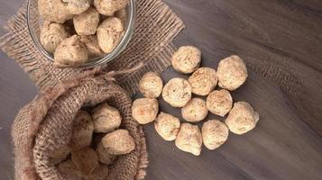Raw soya chunks on dark background. Healthy, nutritious soybean meat, chunks isolated.Vegan food concept. photo