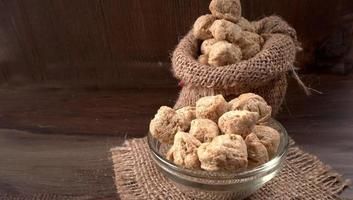 Raw soya chunks on dark background. Healthy, nutritious soybean meat, chunks isolated.Vegan food concept. photo