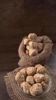 Raw soya chunks on dark background. Healthy, nutritious soybean meat, chunks isolated.Vegan food concept. photo