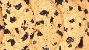 Soft, freshly baked chocolate chip cookies on a gray marble kitchen countertop. American traditional sweet pastry pastry, delicious homemade dessert. Culinary background. Close-up photo