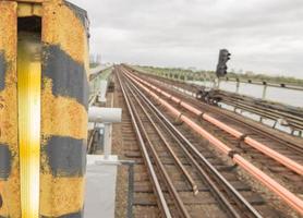 Railroad tracks subway on the bridge in the open air. Railway, rails in city. Travel concept, train trip, rest. The urban metro traffic. photo