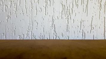 Empty top of a natural wooden table and retro white decorative wall. To display the product. Wooden table and white wall. Empty wooden tabletop, counter, shelf in the wall of the room photo