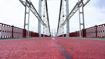 Park pedestrian bridge over the Dnieper River, which connects the central part of Kiev with the park area and the beaches of Trukhanovy Island. Without people. photo