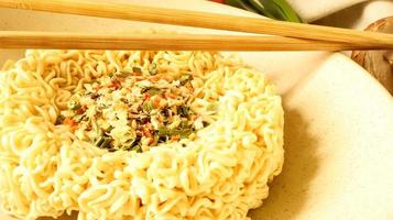 instant noodles with dry seasoning brown bowl, raw noodles. Vegetarian dish. Delicious Asian style dinner. pasta, for the preparation of which it is enough to pour boiling water and wait photo