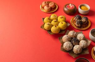 traditional indian sweets on red background flat lay photo