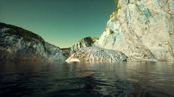 rocky cliff at cold sea water photo