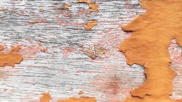 Old wood texture background with shabby orange paint photo