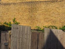 yellow brick wall and fence background photo