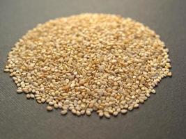 A heap of brown yellow sesame seeds photo