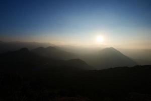 Sunset behind the hills photo