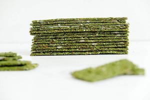 Crispy chips with kelp and spirulina on a white background photo