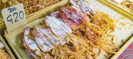 Buy dried squid Thai street food China Town Bangkok Thailand. photo