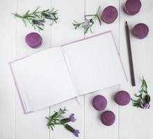 French macaroons, clean notebook and lavender flowers photo