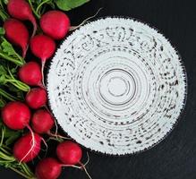 Bunch of radish with empty plate photo