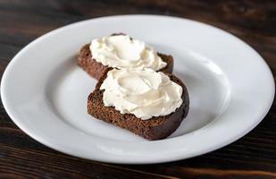 Slices of rye bread with cream cheese photo