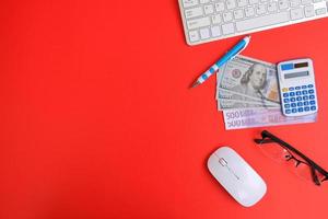 Top view on working space with office equipment and space for text,  concept of money on a yellow background represents finance and banking photo