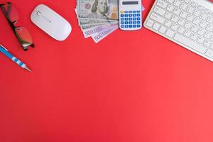 Top view on working space with office equipment and space for text,  concept of money on a yellow background represents finance and banking photo