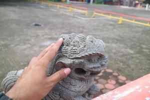 a stone statue of a little lion photo