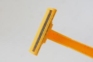 used yellow beard razor on white isolated background photo