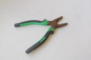 green iron pliers on white isolated background photo