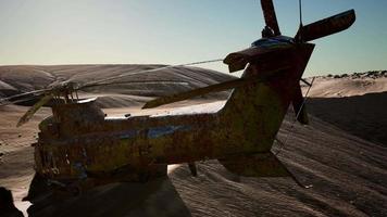 old rusted military helicopter in the desert at sunset video