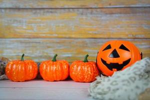 halloween background decorated holidays festive concept - jack o lantern pumpkin halloween decorations on white wooden background for party accessories object photo