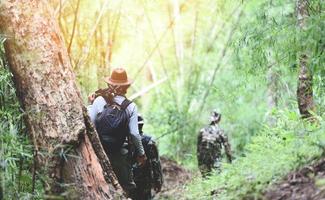 traveler walking in the bamboo forest Men hikers mountain group of friends walking with backpacks and photographic equipment adventure travel tourism sports activity photo