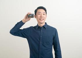 young Asian man holding credit card photo