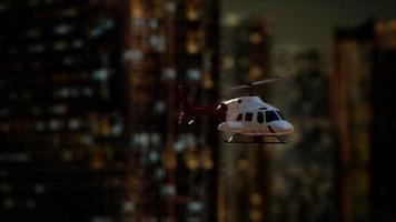 slow motion helicopter near skyscrapers at night video