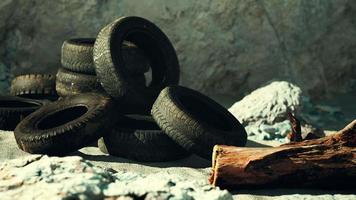 old tires overgrown embedded in the sand video