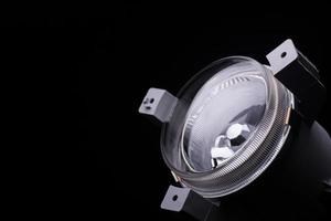 closeup round car headlights on a black background isolated photo