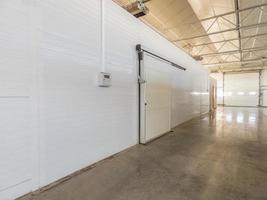 large freezer storage in the factory. closed door from warehouse photo