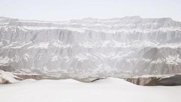 row of sharp dark cliffs standing out from the snow video