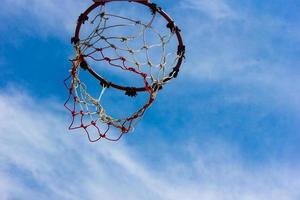Wooden basketball hoop with blue sky background photo