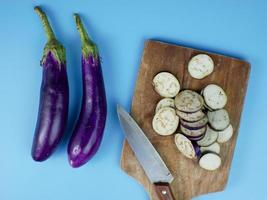 berenjena en rodajas sobre una tabla de cortar de madera. concepto vegetal saludable para la dieta foto