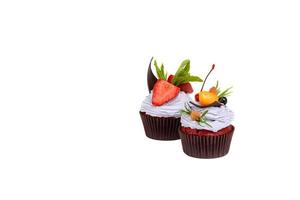 Delicious fresh cakes with berries and white cream on a white background photo