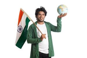 Young man with Indian flag or tricolor with world globe on white background, Indian Independence day, Indian Republic day photo