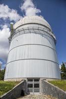 Small astronomical observatory with telescope in Bulgarian mountains at the sunset. photo