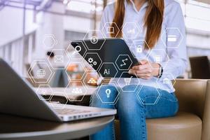 businesswoman or Designer using mobile phone with laptop and digital tablet laptop and document on desk in office with virtual icons network diagram photo
