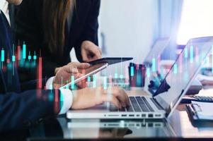 Two professional traides on technical price graph and indicator, red and green candlestick chart and stock trading computer photo