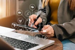 businesswoman or Designer using mobile phone with laptop and digital tablet laptop and document on desk in office with virtual icons network diagram photo