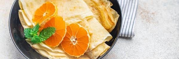 sweet crepe citrus thin pancake breakfast Shrovetide holiday Maslenitsa dessert pancakes meal photo