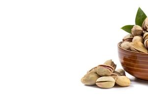 Pistachio in bowl on white background photo