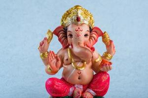 Hindu God Ganesha. Ganesha Idol on blue background. photo