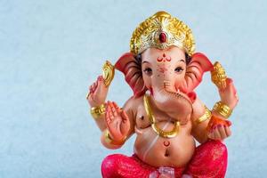 Hindu God Ganesha. Ganesha Idol on blue background. photo