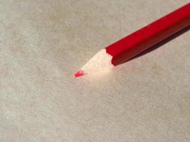 Red pencil over paper photo