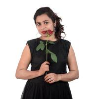 Beautiful young girl or woman holding and posing with red rose flower on white background photo