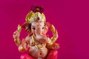Hindu God Ganesha. Ganesha Idol on pink background. photo